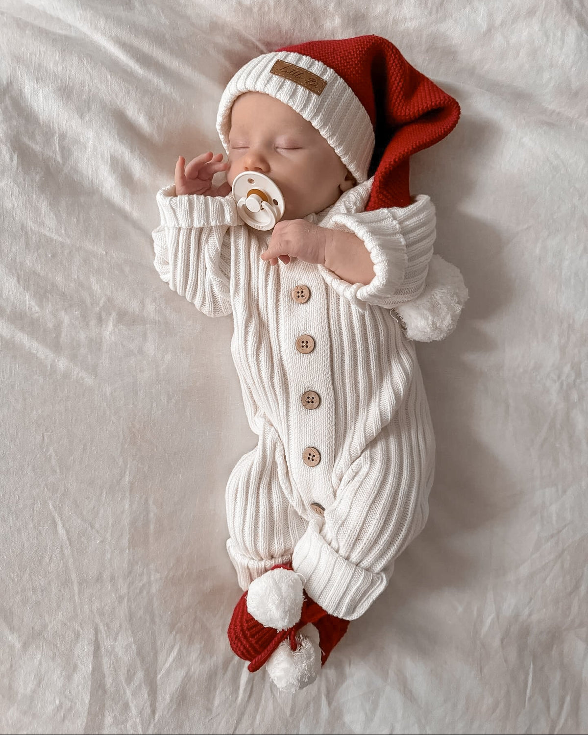 Sleeping baby wearing Little B's Knitted Cotton Classic Christmas Beanie - Red