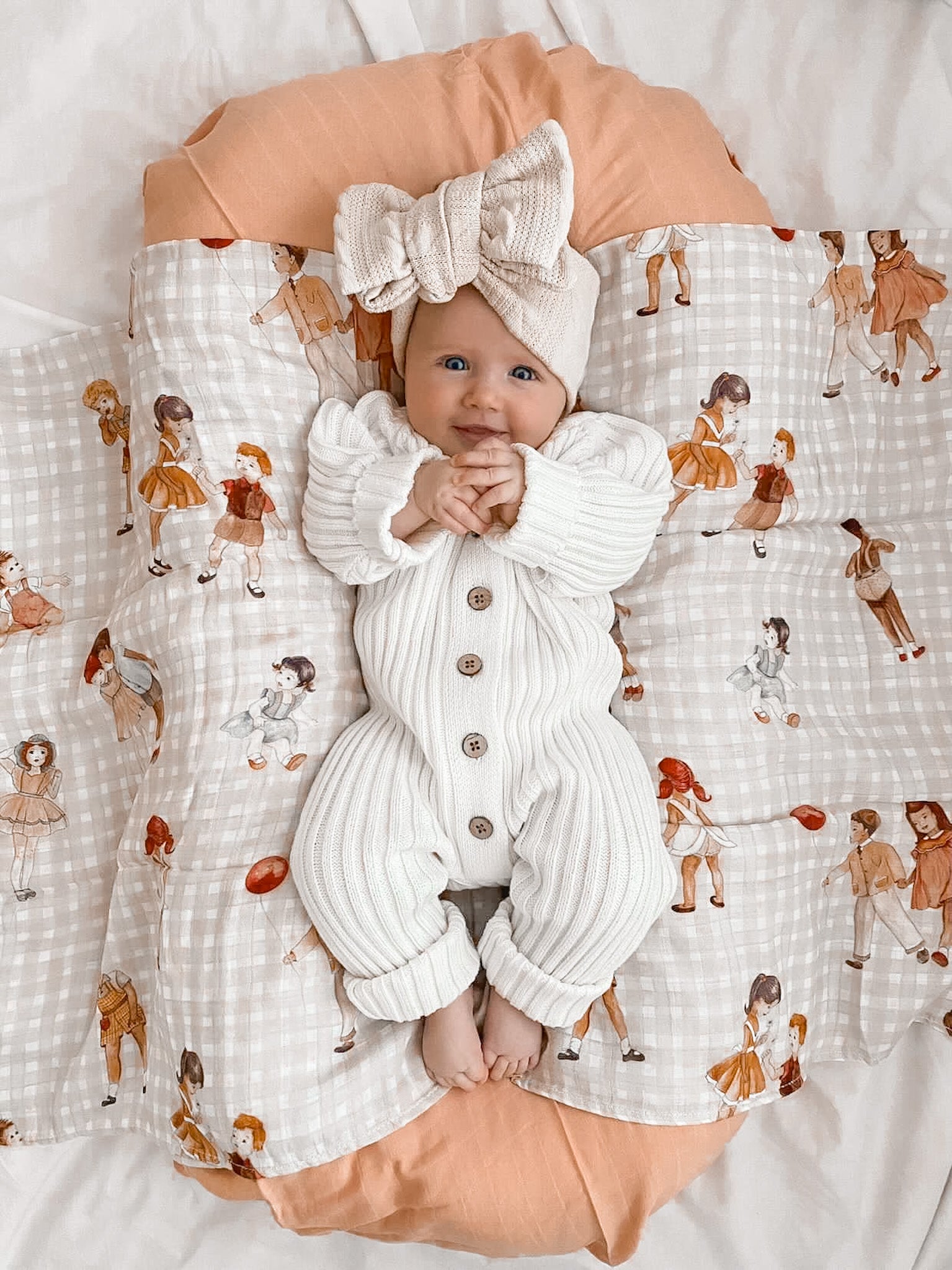 Baby in Knitted Cotton Ribbed Romper - Milk by Little B's Retail, with a large bow headband