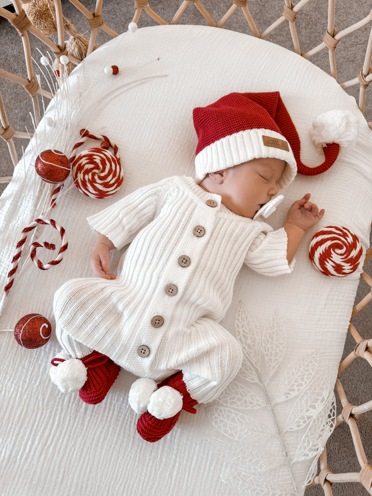 Newborn baby wearing a Little B's Knitted Cotton Classic Christmas Beanie - Red and white outfit