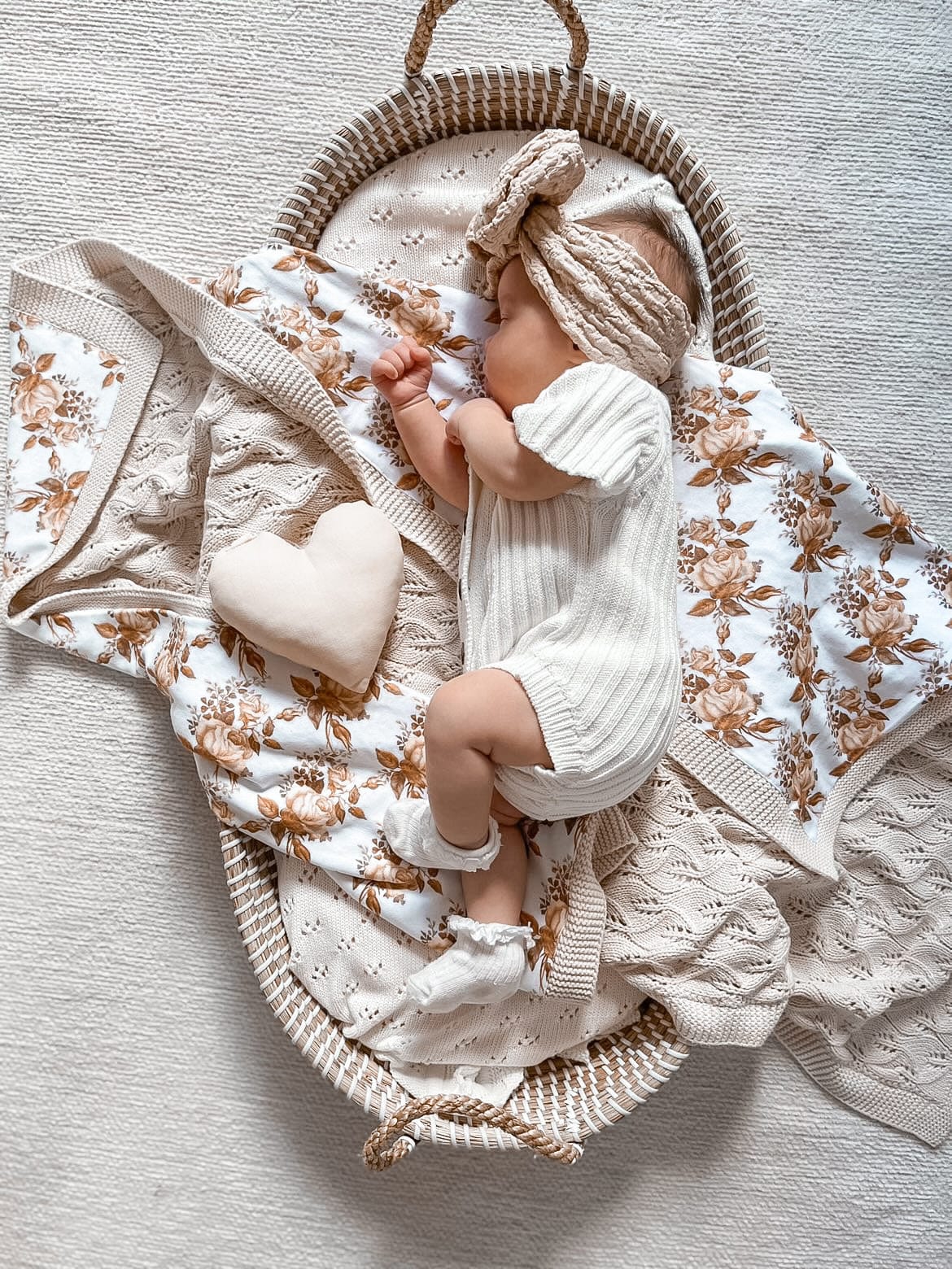 Little B's Knitted Cotton Short Ribbed Romper - Milk, worn by a baby sleeping in a basket