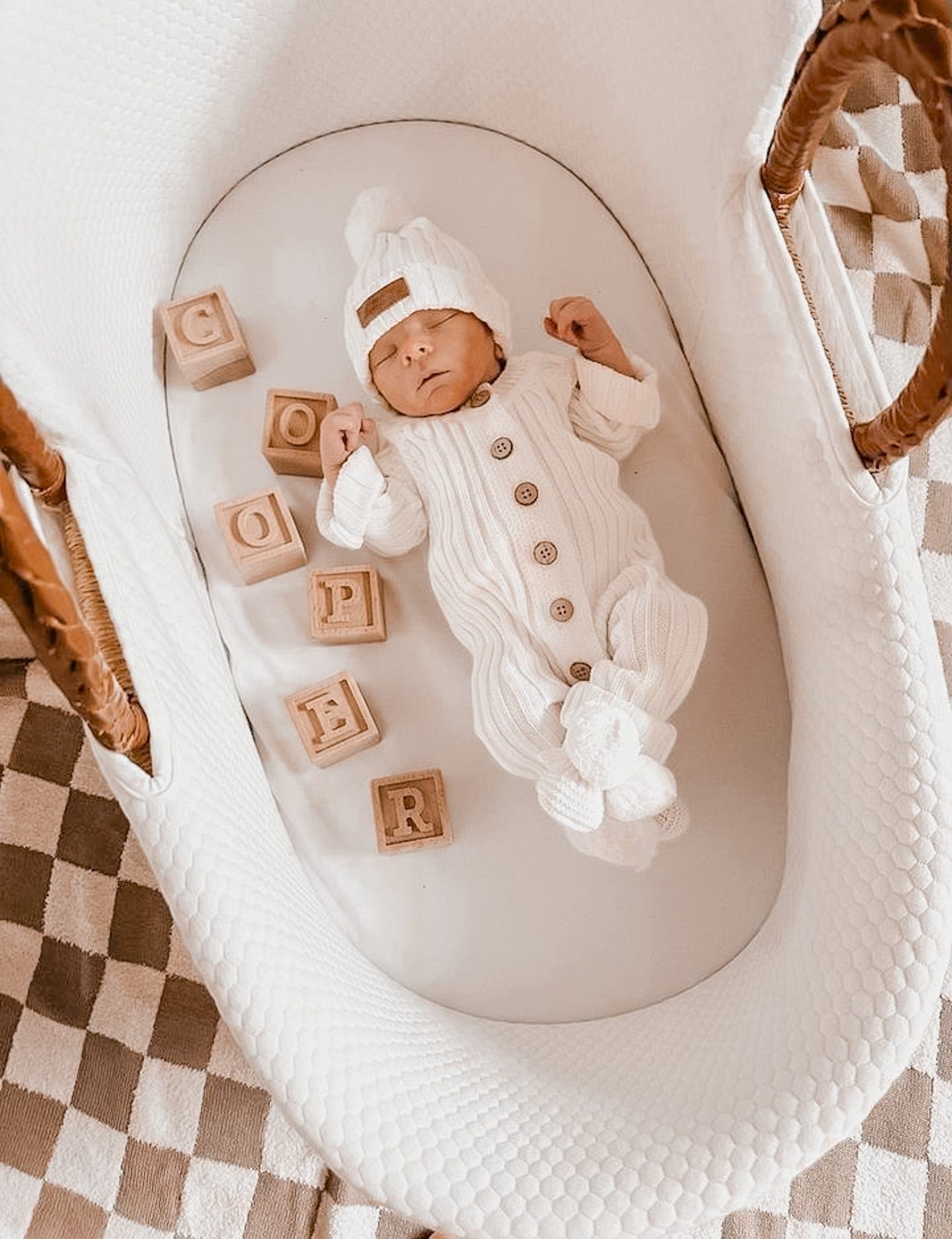Newborn baby wearing a Little B's Retail Knitted Cotton Ribbed Beanie - Milk