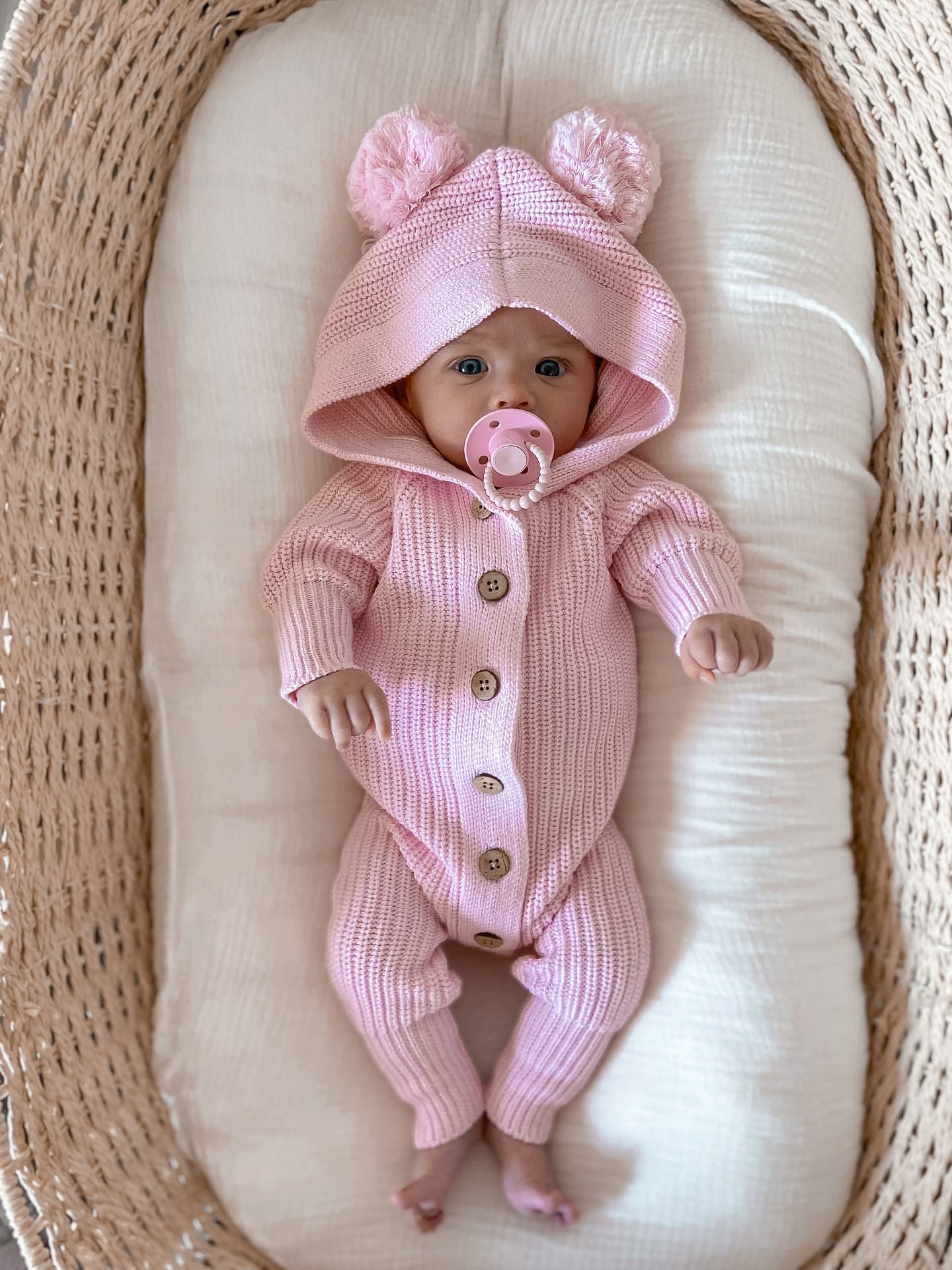 Baby in a pink Knitted Cotton Classic Hoodie by Little B's Retail, with a pacifier