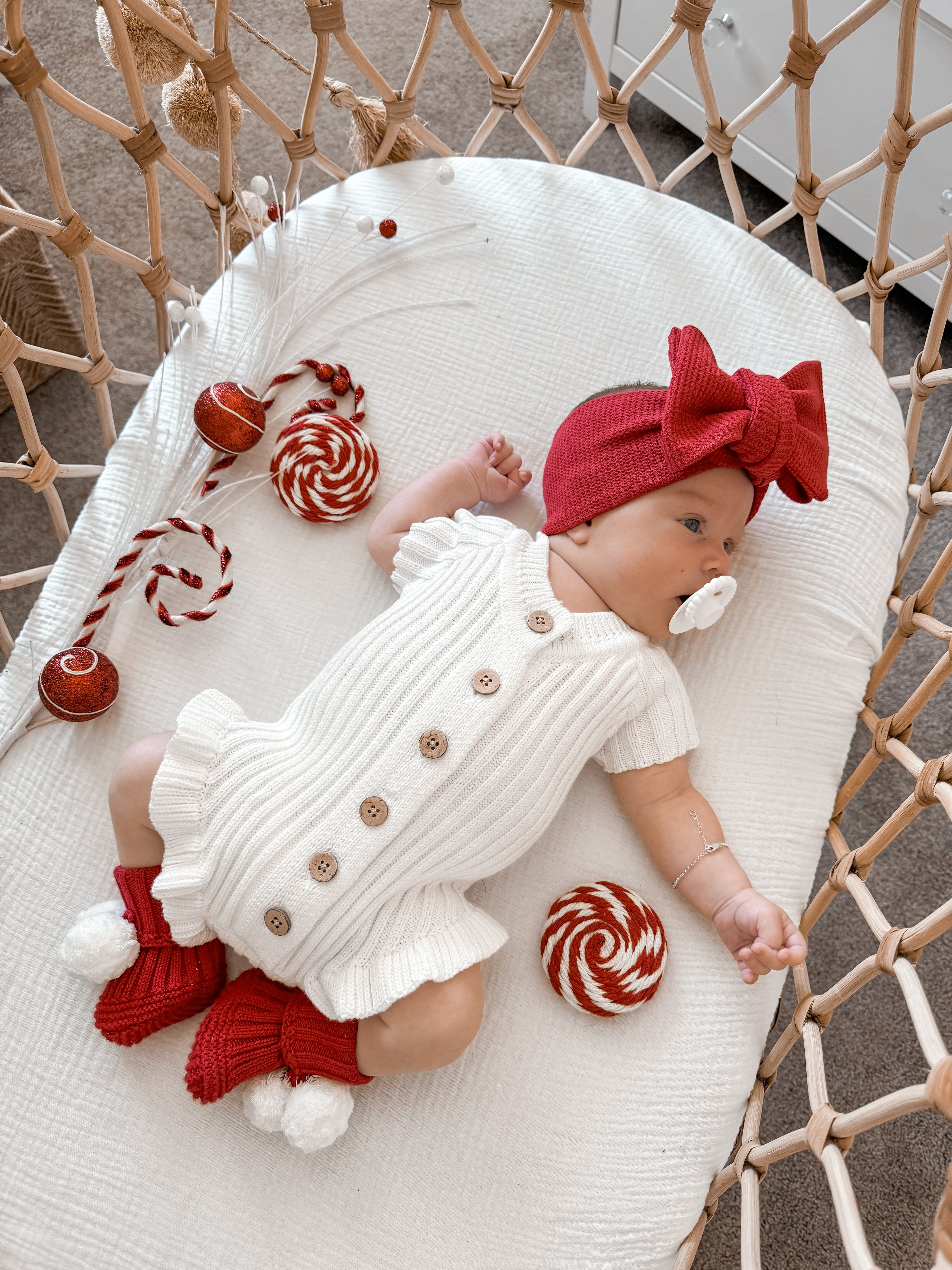 Little B's Waffle Topknot - Christmas on a baby in a crib with a pacifier