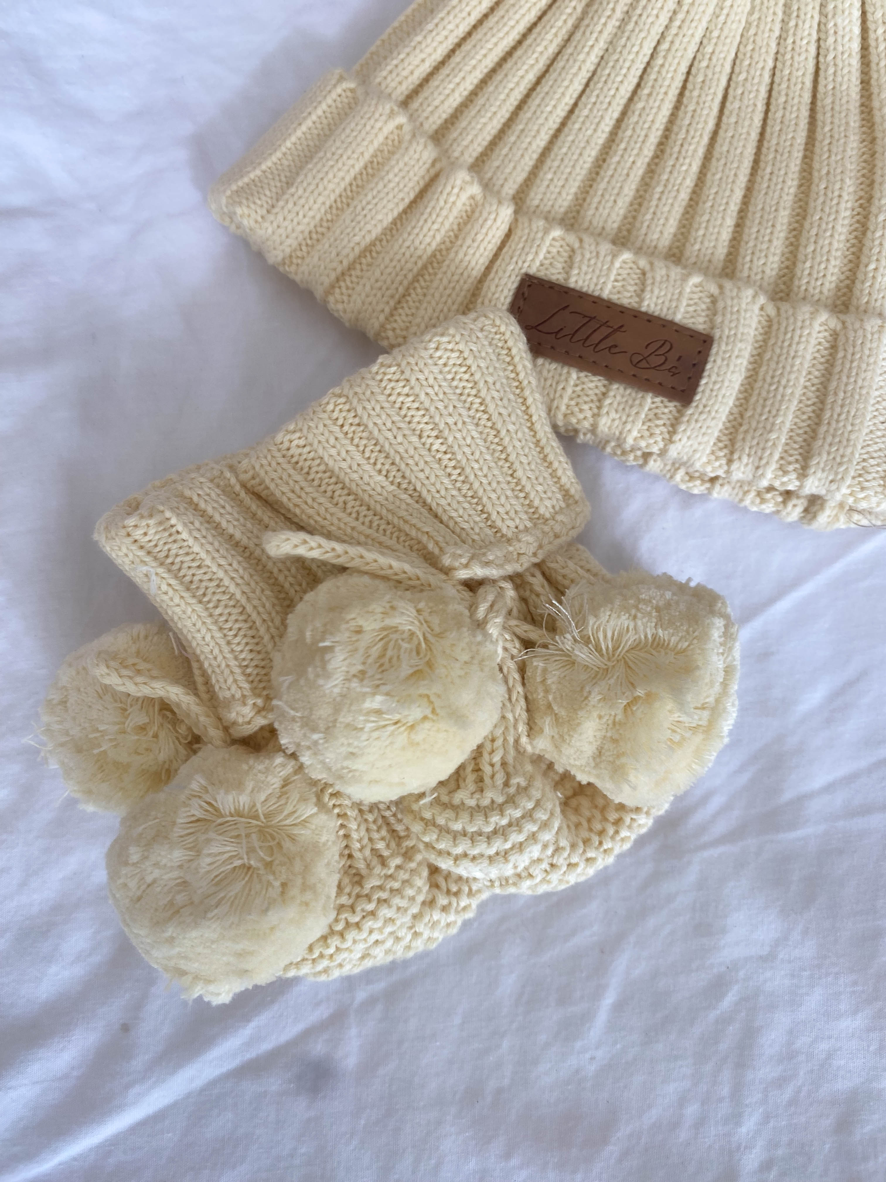 Little B's Knitted Pom Pom Booties in yellow with a matching knitted hat